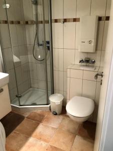 a bathroom with a shower and a toilet at Steinwarder 1 - Haus "Seerose" ST1 055 Steinwarder 1 in Heiligenhafen