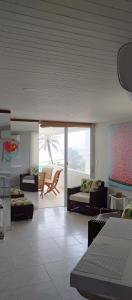 a room with two beds and a living room at Vista Playa in Cartagena de Indias