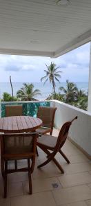 a balcony with a table and chairs and the ocean at Vista Playa in Cartagena de Indias