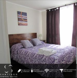 a bedroom with a bed with purple sheets and a window at Santiago Central Suites / Mapocho in Santiago