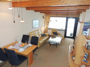 a living room with a couch and a table at Dünenhof DB3 042 Dünenhof in Heiligenhafen