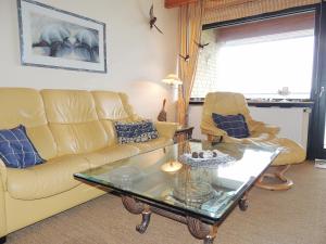 a living room with a couch and a coffee table at Dünenhof DB3 042 Dünenhof in Heiligenhafen