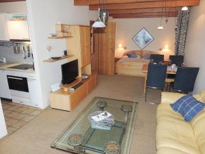 a living room with a couch and a room with a bed at Dünenhof DB3 042 Dünenhof in Heiligenhafen +18 photos