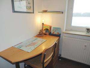 a table and chairs in a room with a window at Dünenhof DB3 042 Dünenhof in Heiligenhafen