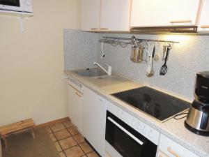 a kitchen with a sink and a stove at Dünenhof DB3 042 Dünenhof in Heiligenhafen