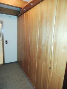 a large closet with wooden doors in a room at Dünenhof DB3 042 Dünenhof in Heiligenhafen