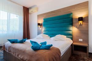 Ένα ή περισσότερα κρεβάτια σε δωμάτιο στο Hotel Orizont
