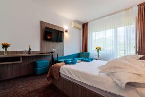 Ένα ή περισσότερα κρεβάτια σε δωμάτιο στο Hotel Orizont