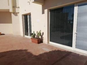 a patio with a large sliding glass door with a plant at Zibibbo Beach Apartments - Trapani in Trapani