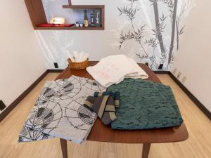 a wooden table with ties on top of it at Tabist Matsuekan in Matsue +31 photos