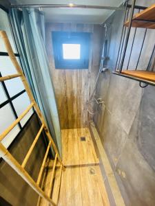 a shower room with a wooden floor and a ladder at 200Mbps Wifi - Penthouse With Acropolis View in Athens
