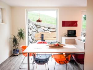 a kitchen and dining room with a table and chairs at Chesa Montana in Maria Alm am Steinernen Meer
