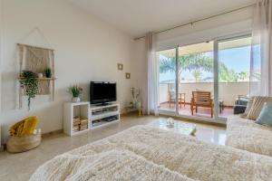 a living room with a bed and a tv at La cala hills in Mijas Costa