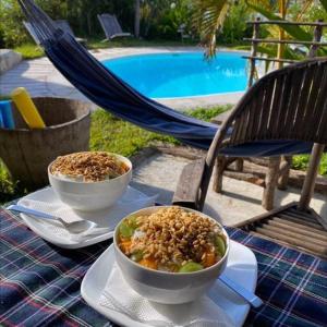 a table with two bowls of food on top of it at Baraka Beach Vilanculos in Vilanculos