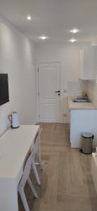 a kitchen with a table and a white counter top at Mina Lux Jelsa in Jelsa