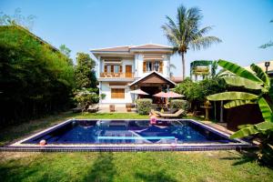 a house with a swimming pool in the yard at Villa b.Maison d'Hôtes Angkor in Siem Reap