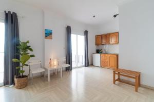 a living room with a table and a kitchen at Kantaros Apartments in Ipsos