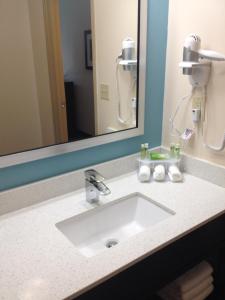 a bathroom sink in front of a large mirror at Holiday Inn Express Montgomery East I-85 by IHG in Montgomery +41 photos