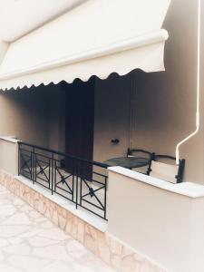 a balcony with a black railing and a table at Eva's apartment in Plataria