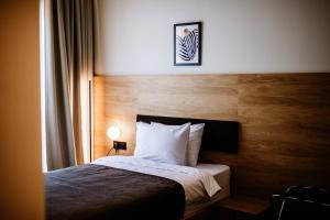 Voodi või voodid majutusasutuse Hotel Septembar toas