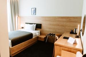 Voodi või voodid majutusasutuse Hotel Septembar toas