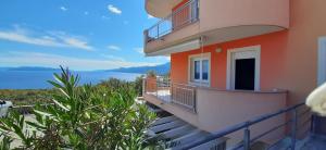 a balcony of a building with a view of the ocean at Apartman Kos in Zamet