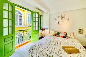 a bedroom with a green door and a bed at Vitamin Home Hoàn Kiếm 35 in Hanoi