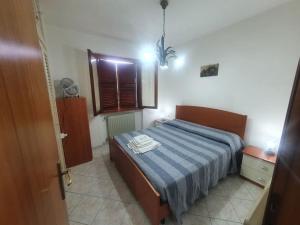 a bedroom with a bed with two towels on it at ççç Holiday Properties Le Vele ççç in Montalto di Castro