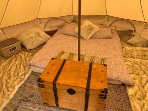 a tent with two beds and a wooden box at Murimäe Winery glamping in Otepää