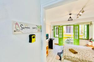 a bedroom with green and white walls and a bed at Vitamin Home Hoàn Kiếm 35 in Hanoi