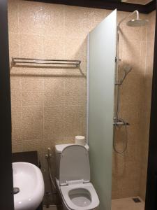 a bathroom with a toilet and a sink and a shower at Mali House in Luang Prabang