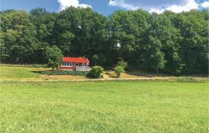 a house with a red roof in a field at Lovely Home In Kungsäter With Kitchen in Kungsäter