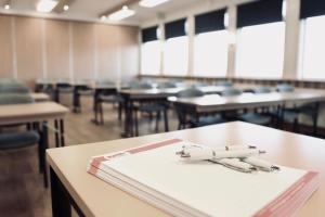 an empty classroom with a book and pens on a table at Torpa Gård in Borensberg