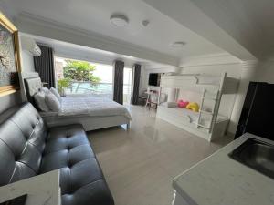 a living room with a bed and a couch at Homestay coco in Vung Tau