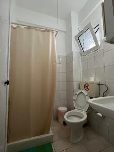 a bathroom with a shower curtain and a toilet at Vangelis in Nea Vrasna