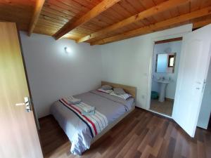 a bedroom with a bed in a room with a mirror at C Dor de Vama Bedrooms in Vama Veche