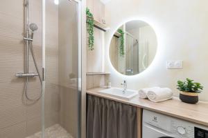 a bathroom with a shower and a sink and a mirror at LE COEUR DE VILLE - Unique in Mont-de-Marsan
