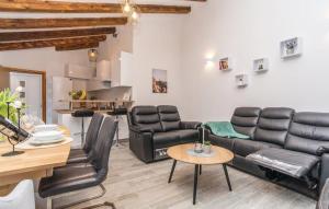 a living room with leather furniture and a table at Villas Pakoštane in Pakoštane