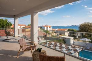 a balcony with a view of the water at Villas Pakoštane in Pakoštane