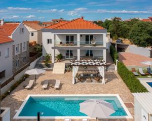 an aerial view of a house with a swimming pool at Villas Pakoštane in Pakoštane