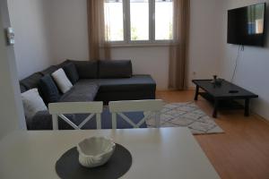 a living room with a couch and a table at Cherry in Korčula