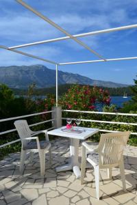 a patio with a table and two chairs and an umbrella at Cherry in Korčula