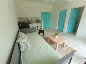 a living room with a bed and a table at Beseco Bed and Breakfast in Benaulim