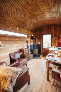 a living room with a couch and a table at La RouLodge du Veilleur - Hôtel Insolite in Ermeton-sur-Biert