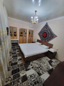 a bedroom with a bed and a chandelier at Hotel Motrid in Samarkand