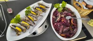 two plates with different types of food on a table at Boutique hotel Lili in Rovinj