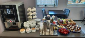 a kitchen counter with cups and utensils next to a microwave at Boutique hotel Lili in Rovinj
