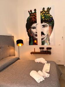 1 dormitorio con 1 cama con una pintura en la pared en Welcome Catania, en Catania