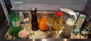 a kitchen counter with bottles and spoons in a sink at Boutique hotel Lili in Rovinj