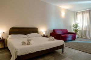 CaninoにあるAgriturismo Cerrosugheroのベッドルーム1室(大型ベッド1台、赤い椅子付)